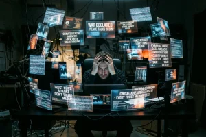 Explore 11 An individual overwhelmed by multiple digital screens representing political misinformation and news overload.