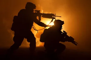 silhouette of two figures with weapons in smoke